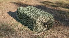 a large round bale of hay sitting in the grass