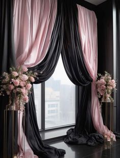 black and pink curtains in front of a window with flowers on the windowsills