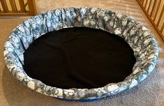 a round dog bed on the floor in a room