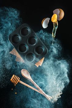 an image of some food that is in the air and on top of it are utensils