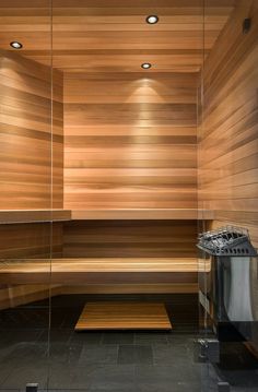 an empty sauna with wooden walls and benches