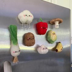 stuffed vegetables are hanging on the side of a refrigerator freezer with magnets attached to it