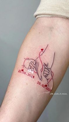 a couple holding hands tattoo on the arm