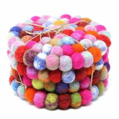 a pile of multicolored balls sitting on top of each other in front of a white background