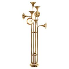 an old brass trombone is standing upright on a white background and has four horns attached to it