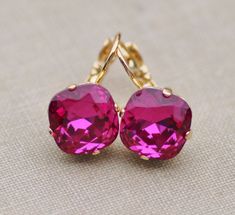 "Gorgeous new earrings using genuine Swarovski elements. The rhinestone is cushion cut and fucshia in color. It is hot pink and measures 12mm (1/2\"). Stones are hand set into premium earring settings. Earrings have a lever back ear wire soldered to the back. Or, you can choose post style earrings, which will have a hypoallergenic post located in middle back. Studs measure 1/2\" around, while lever back ear 1\" long. Shown in gold, but also come in silver or antique brass. Please choose desired Cushion Earrings, Hot Pink Earrings, Pink Tourmaline Crystal, White Opal Earrings, Crystal Teardrop Earrings, Gemstone Jewelry Handmade, Wedding Jewelry Earrings, Crystal Drop Earrings, Pink Earrings