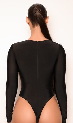 a woman wearing a black bodysuit with long sleeves and high cut butts is seen from the back