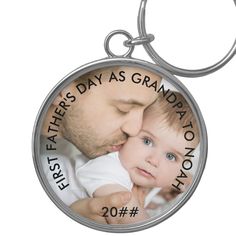 a father's day keychain with an image of a baby and his dad