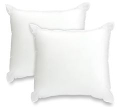 two white pillows sitting next to each other