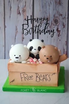 three bears sitting in a box on top of a wooden board with the words happy birthday