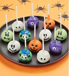 there are many halloween cake pops on the plate