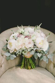 a bouquet of flowers sitting on top of a chair