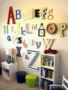 a child's room with alphabets, bookshelves and toy bins