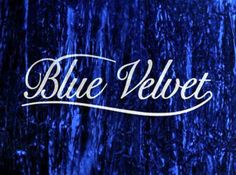 the word blue velvet written in white ink on a dark background with trees and grass