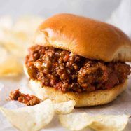 a sloppy joe sandwich with chips on the side