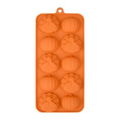 an orange plastic tray with six pumpkins in the shape of a cookie molder