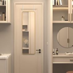 a white door in a bathroom next to a sink and mirror with shelves on the wall