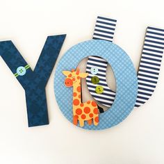 the letter y is made out of paper and has a giraffe on it