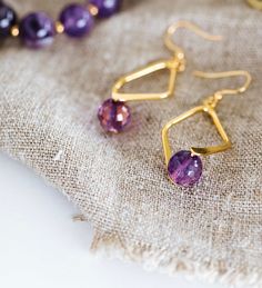 A faceted Amethyst bead set in a double sided diamond shaped frame creates demure drop earrings. 8mm faceted amethyst beadgold plated brass double sided diamond shaped bailgold plated brass french ear wires drop: 2"width: 3/4" Handmade in Lincoln, Nebraska Amethyst Jewellery, Lincoln Nebraska, Bead Set, Amethyst Jewelry, Amethyst Beads, Diamond Shaped, Jewelry Ideas, Ear Wires, Nebraska