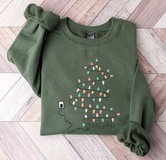 Let's Get Lit Sweatshirt - Christmas Lights Sweater - Christmas Party Hoodie - Bright Christmas Sweater - Funny Gift For Christmas Party Description How can I order? 1️) Please review all the information provided before placing an order 2️) Select the shirt type and size. 3️) Select the color of the shirt using the following options. 4️) Need more Items? Add the current item in the cart. And If you like to add more items to your order please press the back button and repeat steps 1-4 again. 5️) Christmas Sweaters Lit, Christmas Light Tree, Light Up Sweater, Christmas Green Sweatshirt With Graphic Print, Christmas Sweatshirts & Hoodies Funny, Christmas Graphic Print Relaxed Fit Sweatshirt, Christmas Sweater Funny, Light Tree, Heat Press Printing