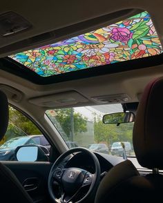 the interior of a car with a colorful stained glass window