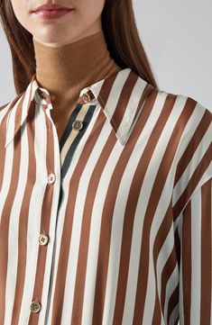 A retro point collar tops this luxurious silk-enriched button-up covered in crisp vertical stripes and perfect for elevating your workwear attire. Front button closure Point collar Long sleeves with button cuffs 68% viscose, 32% silk Hand wash, line dry Imported