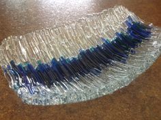 several toothbrushes are lined up in plastic wrap on the counter top, with blue and white tips