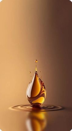 a drop of liquid that is floating in the water on a brown background with reflections