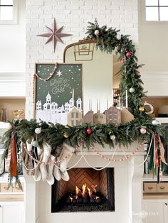 a decorated fireplace with stockings and christmas decorations