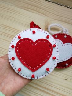 two red and white heart shaped ornaments on a table