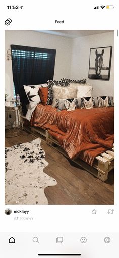 an instagram photo of a bed with orange sheets and pillows on top of it