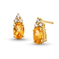 Make their November birthday a magical one with these stunning citrine and diamond stud earrings. 10K gold Each earring features a 6.0 x 4 oval-shaped golden-yellow citrine center stone Trios of diamonds top each center stone 1/10 ct. t.w. of diamonds Post earrings; friction backs Yellow Gold Earrings With Gemstone Accents, 14k Yellow Gold Diamond Gemstone Earrings, Yellow Gold Diamond Gemstone Earrings In 14k, 14k Yellow Gold Diamond Earrings With Gemstone, Formal Yellow Gold Topaz Earrings, Gold Oval Hallmarked Diamond Earrings, 14k Gold Diamond Gemstone Earrings, Gold Oval Diamond Earrings, Hallmarked, Fine Jewelry Diamond Earrings With Gemstone Accents