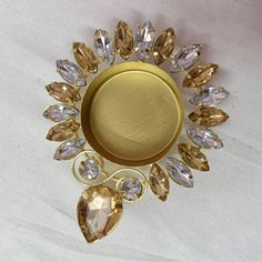 a gold plate with many different colored stones on it