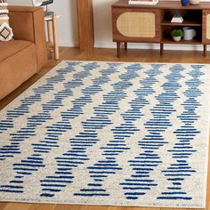 a blue and white rug in a living room