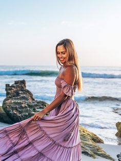 Crafted of lightweight, airy fabric in a flowy silhouette, our Belle maxi dress is the perfect summer staple for every occasion—from a beach vacation to date night or even a girls’ night out. Designed for both comfort and style, the dress features a smocked bodice, strappy back and tassel-tie waist. What do we love most about this dress? The flutter sleeves can be worn two ways: off the shoulder or as straps. Convertible flutter sleeves Smocked bodice with buttons Side on-seam pockets Tassel-tie Beach Dress Photoshoot, Scarlet Begonias, Thailand Dress, Pineapple Dress, Chic Maxi Dresses, Lavender Dresses, Senior Picture Outfits, Belle Dress, Flowy Maxi Dress