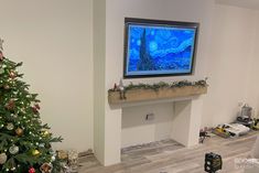 a living room with a christmas tree in the corner and a painting on the wall