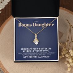 Imagine her reaction when she opens this stunning gift! The Alluring Beauty necklace features a petite ribbon shaped pendant that is sure to dazzle your special someone. Whether it's a birthday or anniversary, make sure to get her a gift she will love for years to come. 14k white gold finish or 18k yellow gold finish over stainless steel 7mm cubic zirconia Pendant dimensions: 0.8" (20mm) height / 0.4" (10mm) width Adjustable length: 18" - 22" (45.72 cm - 55.88 cm) Lobster clasp Your piece is lov To My Bonus Daughter, Bonus Daughter, You Are The Sun, Always Shine, Beauty Necklace, Modern Accessories, To My Mother, Future Wife, Always Love You