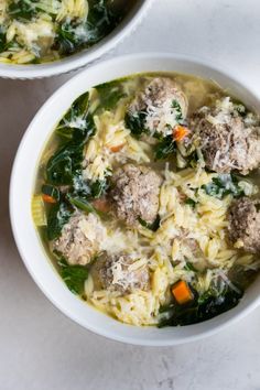 two white bowls filled with meatball soup on top of a marble counter next to each other