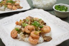 two white plates topped with shrimp and rice