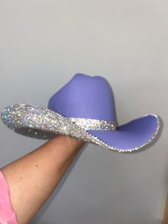 Inspired by Taylor Swift's Eras Tour, we custom made a purple hat with crystal rhinestones and a matching hat band. Sizing: This hat is a a one size fits all! The band on the inside is a stretchy band; all orders come with a custom Rhinestone Cowgirl dust bag and foam pieces that can be stuck behind the hat band to reduce the size. Blinged Out Cowboy Hat, Bejeweled Cowboy Hat Taylor Swift, Rhinestone Cowboy Hat Outfit, Eras Tour Hat Ideas, School Spirit Cowboy Hats, Bedazzled Fitted Hat, Decorated Hats Diy, Senior Cowboy Hats