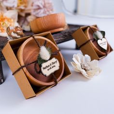 two small wooden boxes with flowers in them