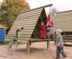 children playing on a wooden structure in the sand