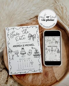 a phone sitting next to a calendar on top of a wooden table with a sign that says save the date