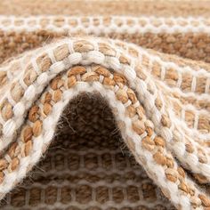 a close up view of a carpet with white and brown colors