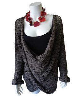 a mannequin wearing a black top with red flowers on it's neck