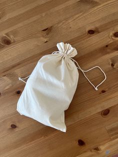 a white bag sitting on top of a wooden floor