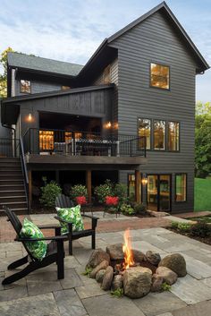 a fire pit sitting in front of a large house