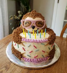 a birthday cake with a hedge wearing glasses