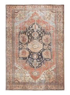 an orange, blue and brown rug with ornate designs on the bottom half of it