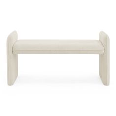 a white bench sitting on top of a white floor